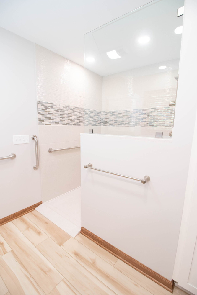 bathroom renovation with walk in shower and mosaic tile accent by Odd Fellows Contracting in Mason MI