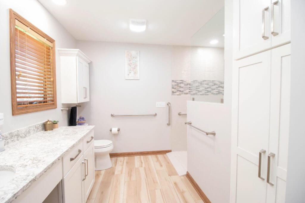 completed bathroom remodel with accessible walk in shower and modern finishes by Odd Fellows Contracting in Mason MI