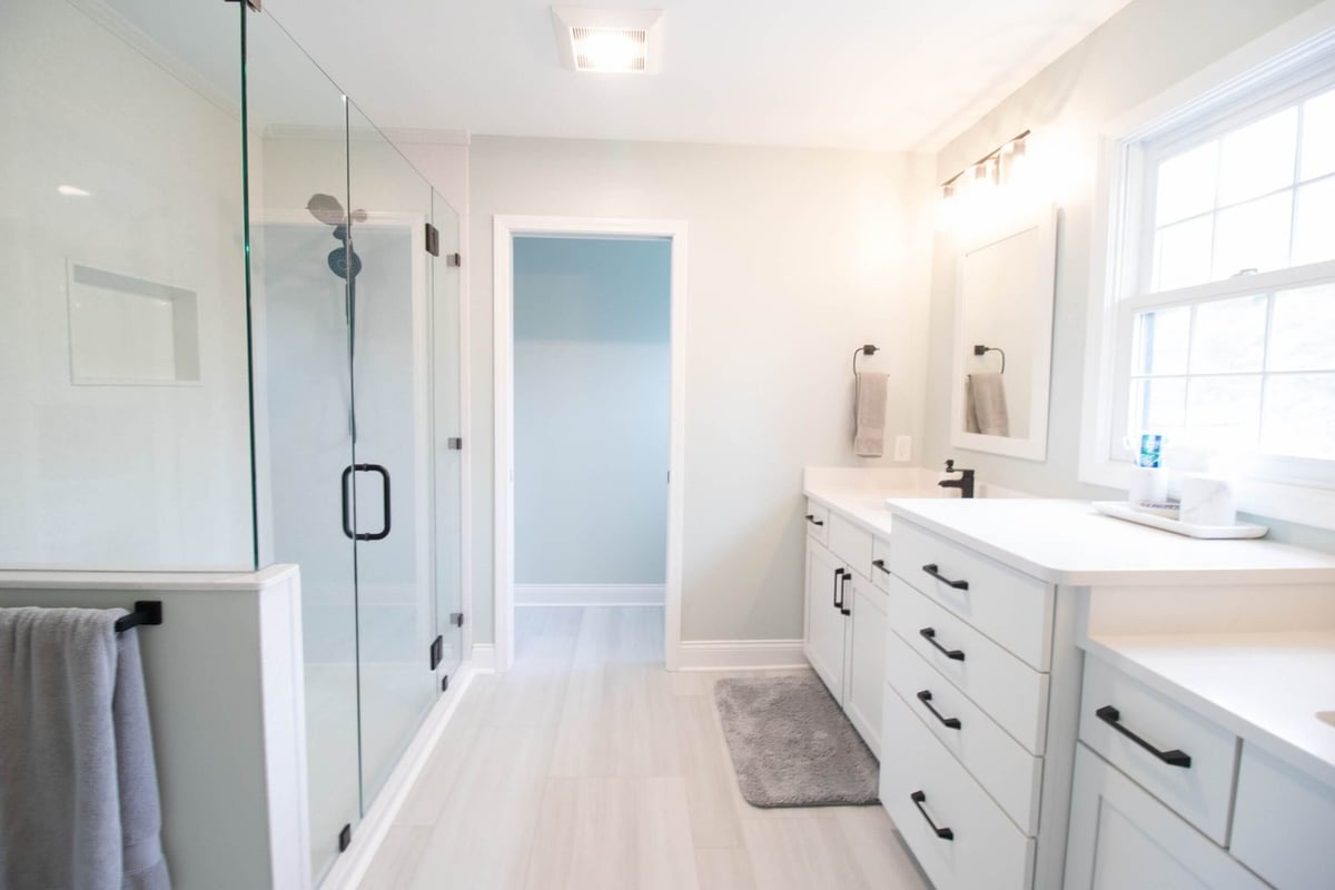 bathroom renovation featuring modern mirrors and black hardware by Odd Fellows Contracting in Holt MI