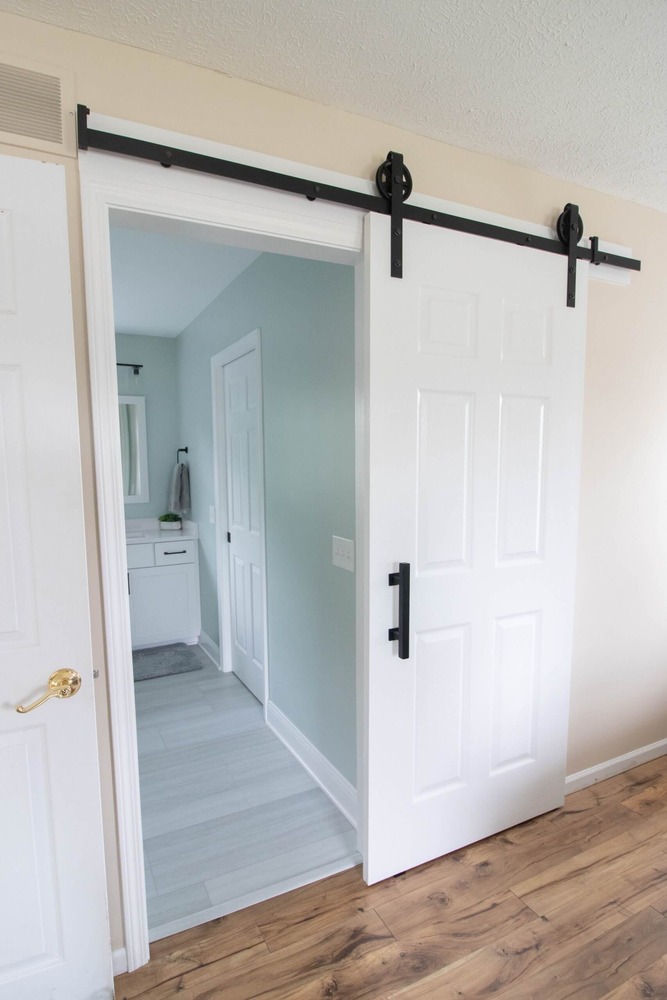 bathroom renovation featuring modern walk in shower with black hardware by Odd Fellows Contracting in Holt MI