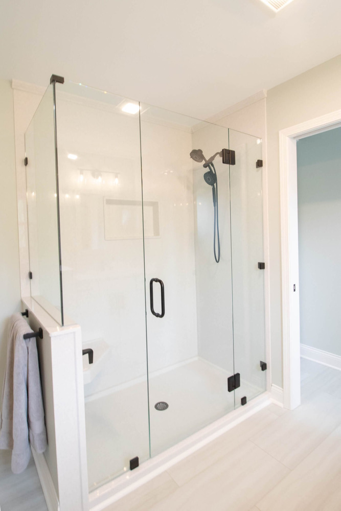 finished bathroom remodel showing glass shower and vanity area by Odd Fellows Contracting in Holt MI