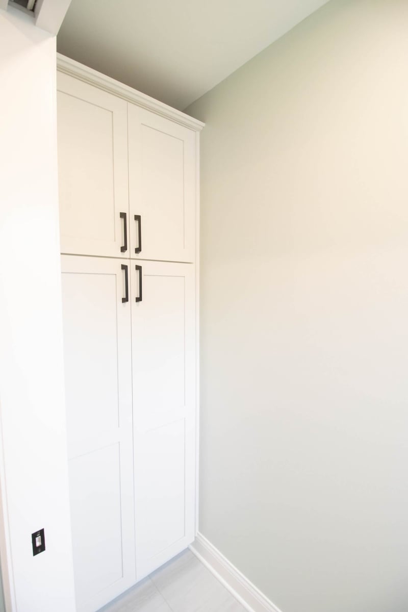 finished bathroom remodel with tall storage cabinet and modern hardware by Odd Fellows Contracting in Holt MI