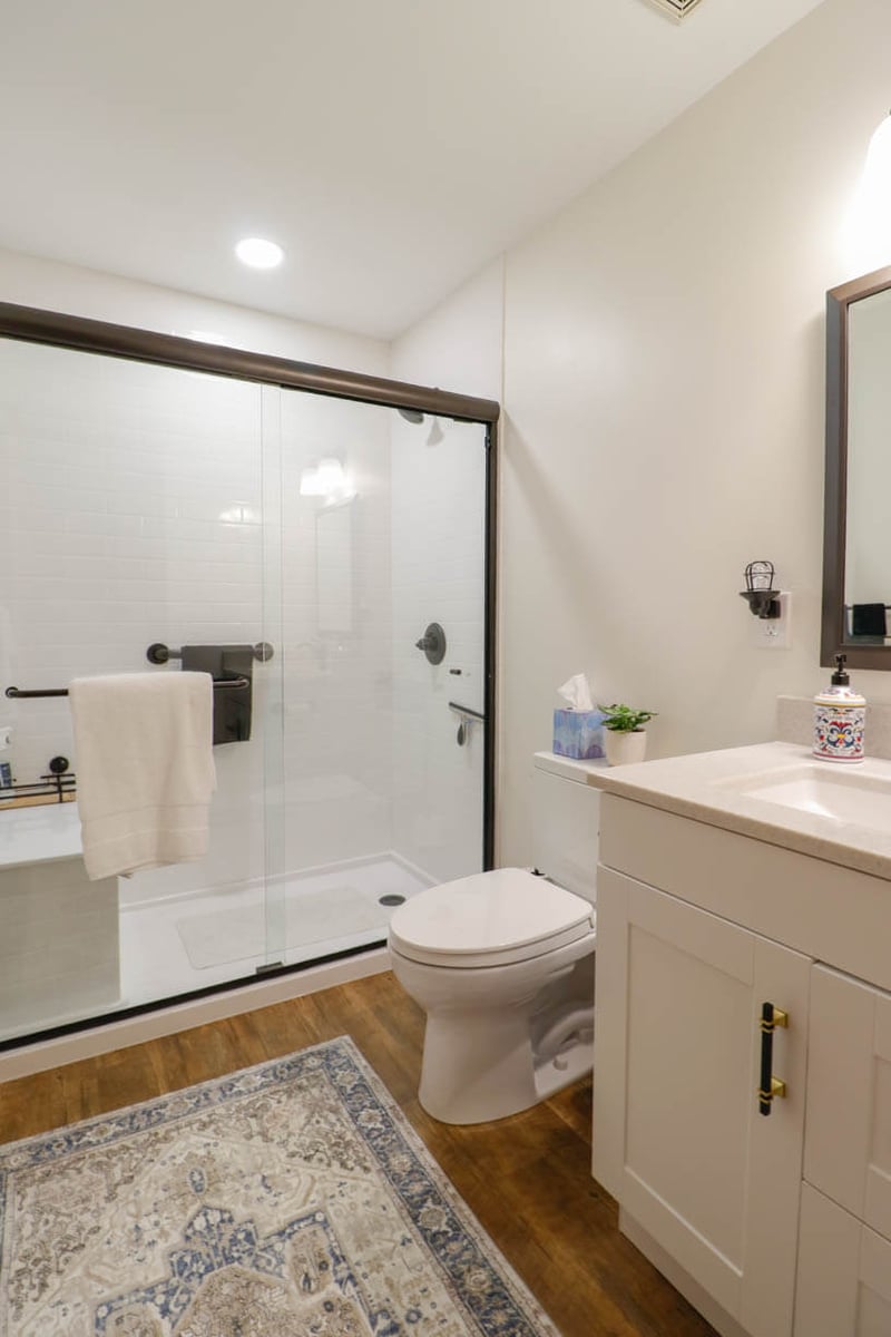Holt, MI bathroom renovation by Odd Fellows Contracting featuring tiled shower and new vanity installation.