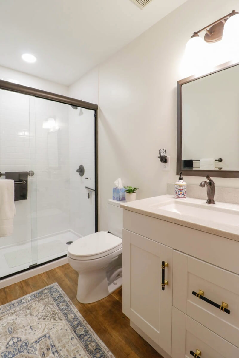 Modernized bathroom in Holt, MI remodeled by Odd Fellows Contracting with updated fixtures and flooring.