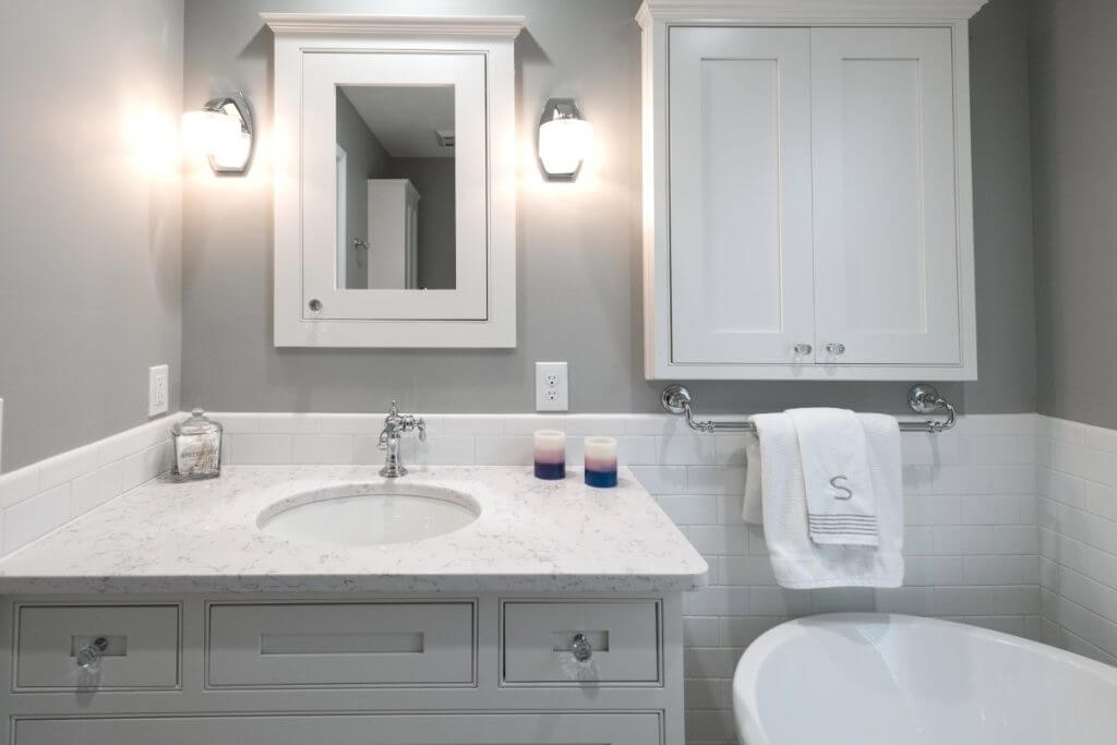 Bright master bathroom with vanity cabinetry and soaking tub remodeled by Odd Fellows Contracting in Williamston, MI
