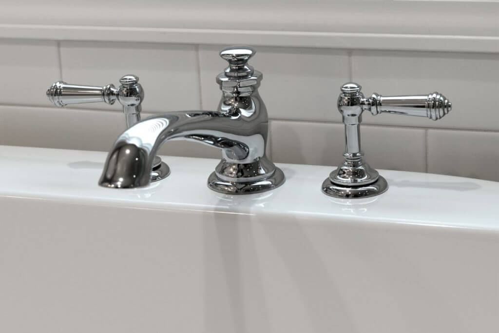 Close-up of freestanding tub faucet and fixtures in Williamston MI master bathroom remodel by Odd Fellows Contracting