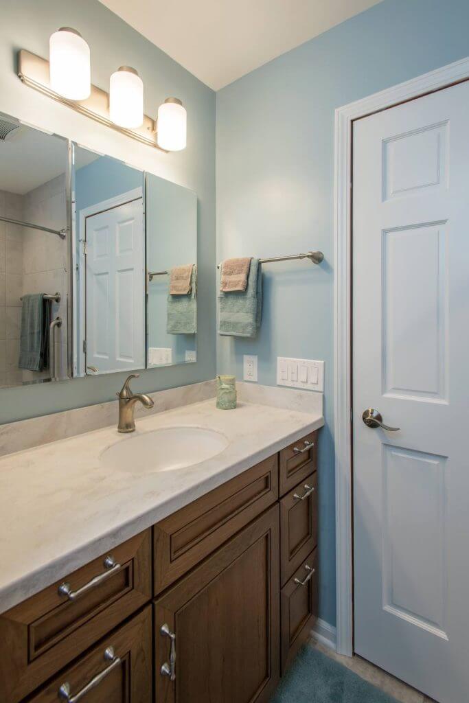 Bathroom vanity with mirror cabinet and lighting in Holt MI bathroom remodel by Odd Fellows Contracting