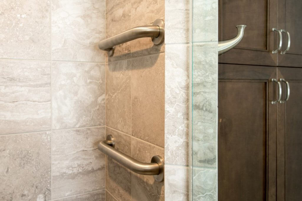Close-up of shower safety grab bar in Holt MI bathroom renovation by Odd Fellows Contracting