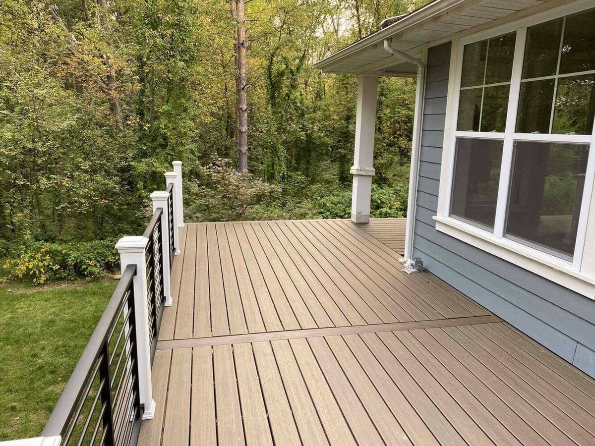 backyard deck with composite boards and railing by Odd Fellows Contracting in Lansing, MI