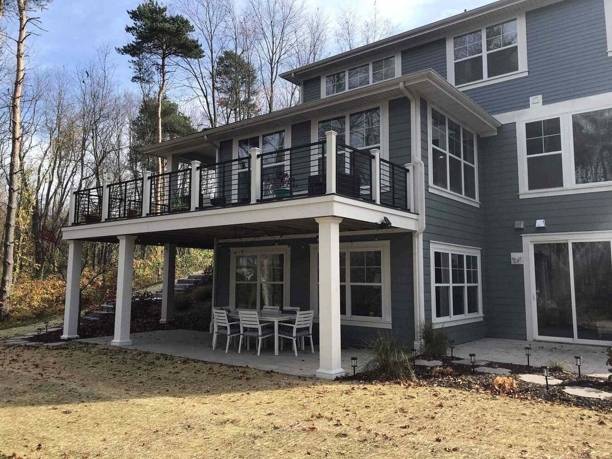 side view of elevated deck expansion with railing system by Odd Fellows Contracting in Lansing, MI
