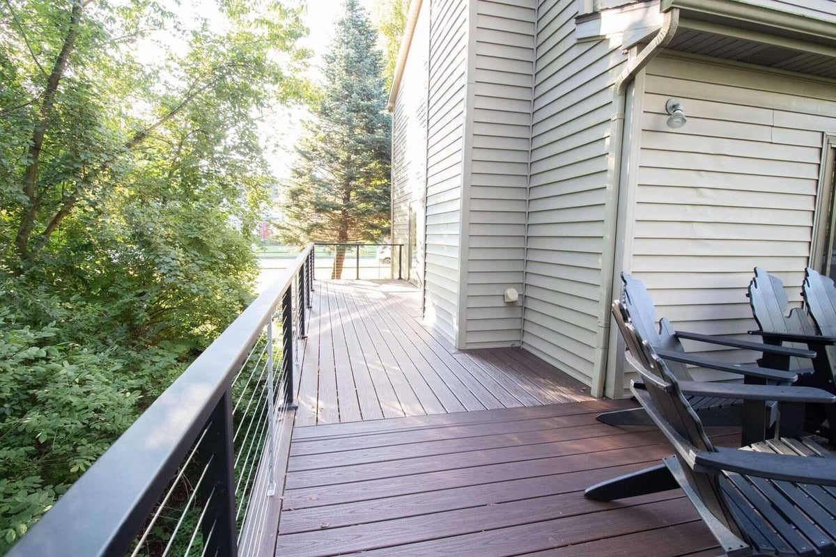 side view of elevated composite deck with cable railing system in Haslett, MI
