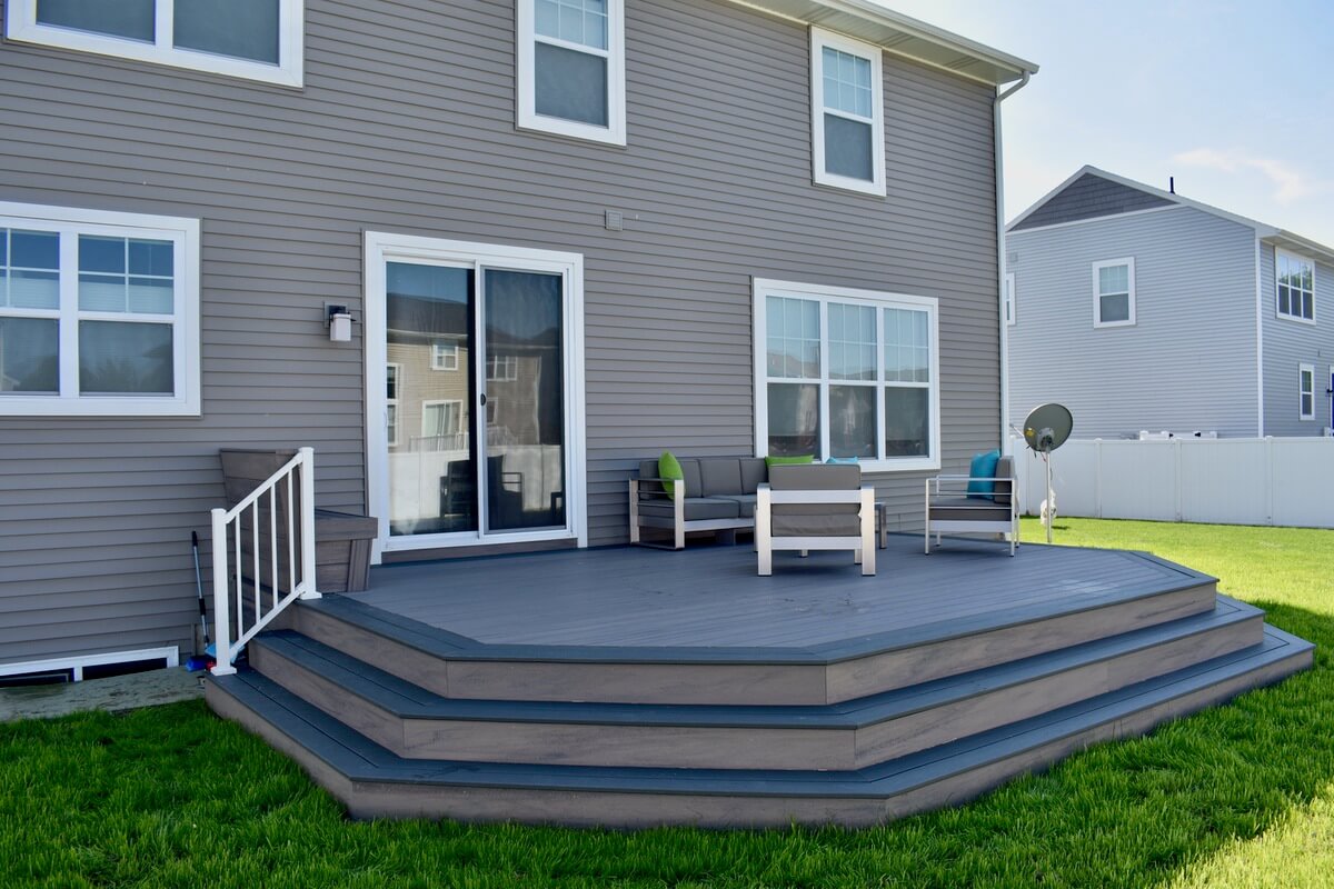 backyard composite deck installation with steps and seating area in Okemos, MI