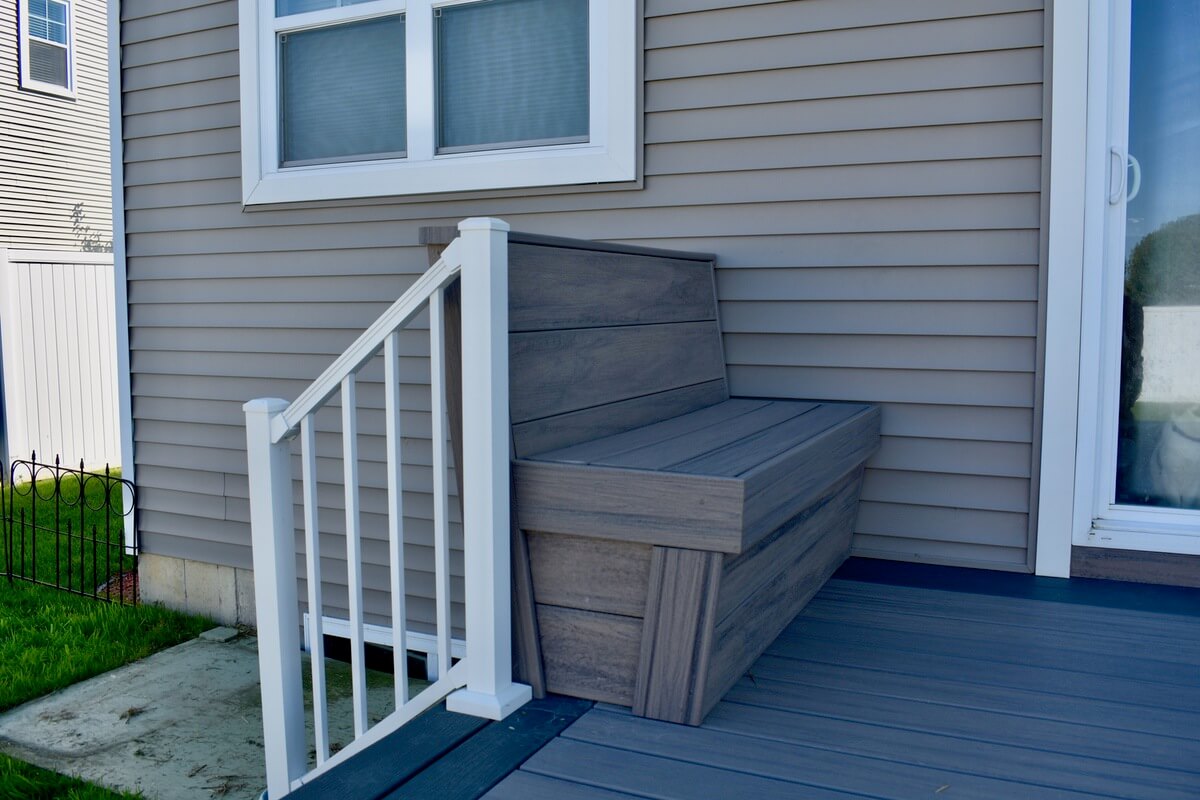 composite deck with built in bench seating by Odd Fellows Contracting in Okemos, MI