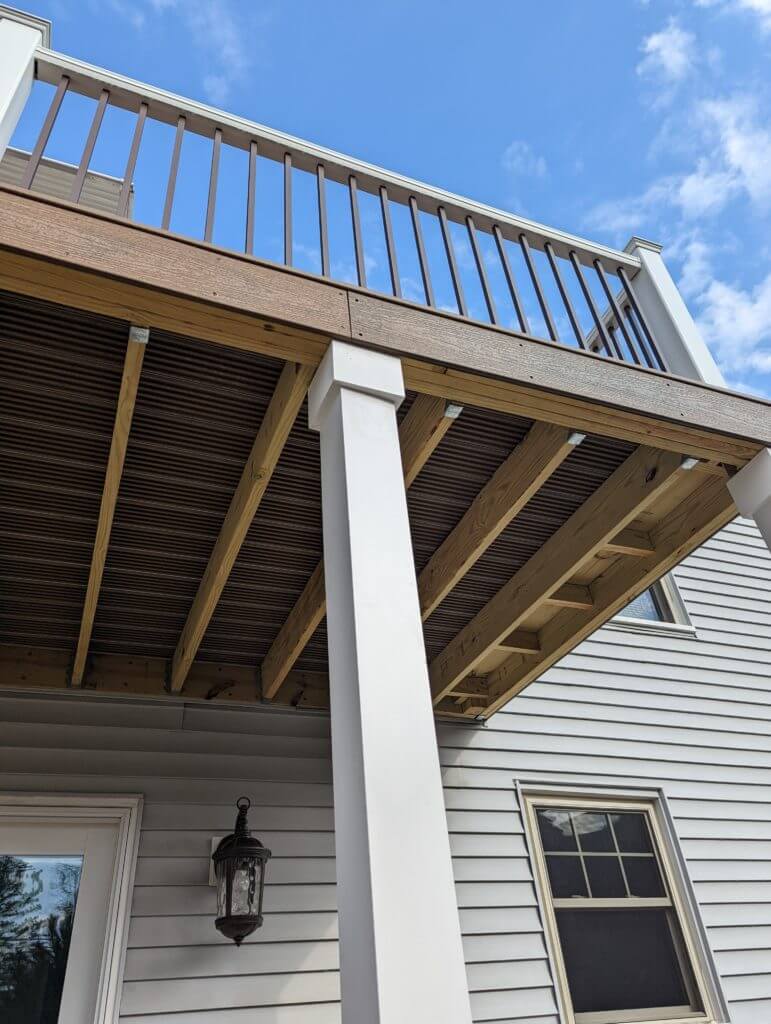 close up of second story deck railing and support columns by Odd Fellows Contracting in Lansing, MI