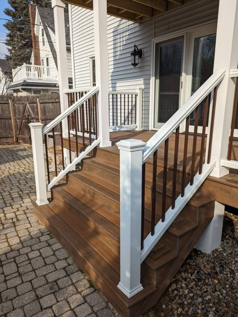 deck staircase leading to elevated backyard deck by Odd Fellows Contracting in Lansing, MI