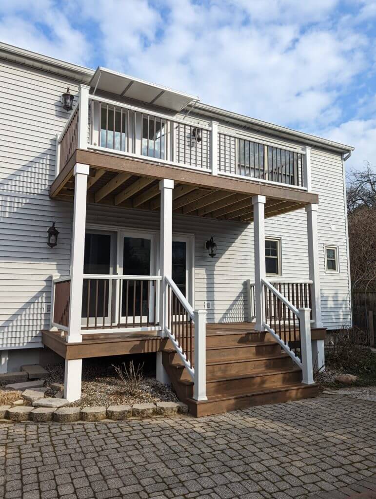 elevated deck construction with support posts and framing by Odd Fellows Contracting in Lansing, MI