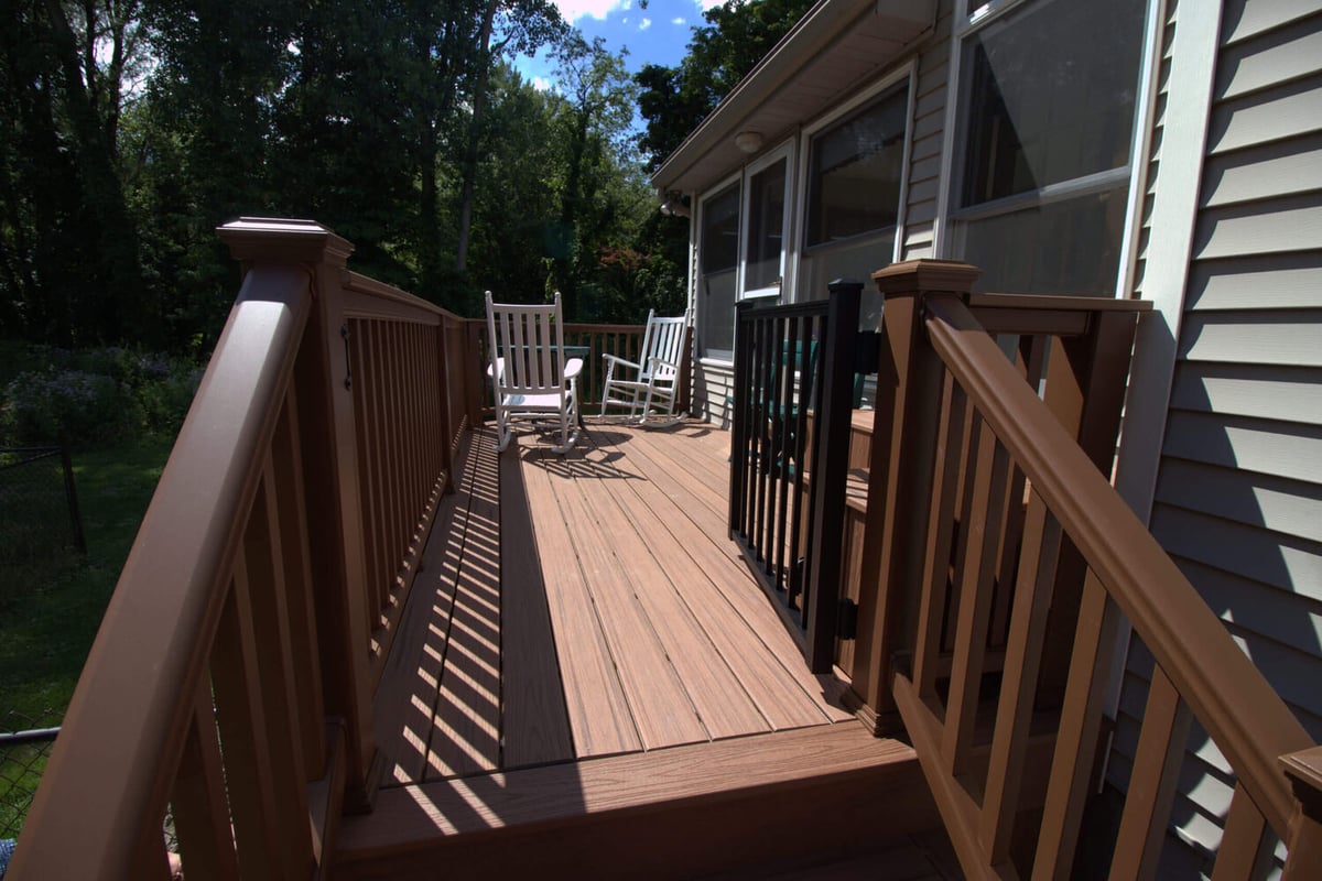 Composite deck walkway and railing system from deck remodel by Odd Fellows Contracting in Haslett, MI