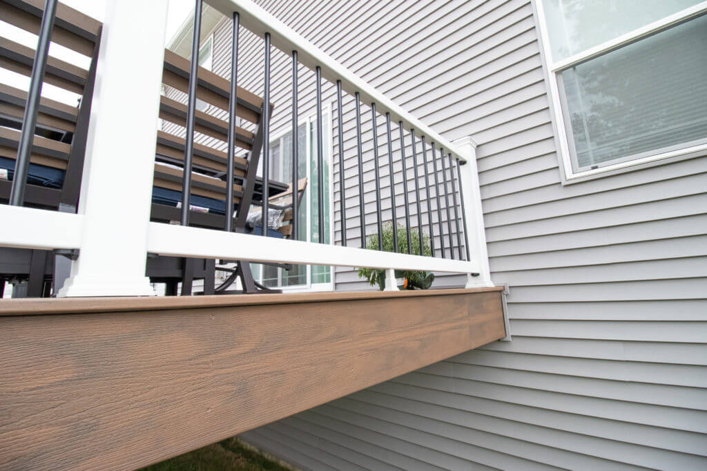 deck railing and composite deck edge detail by Odd Fellows Contracting in Williamston, MI