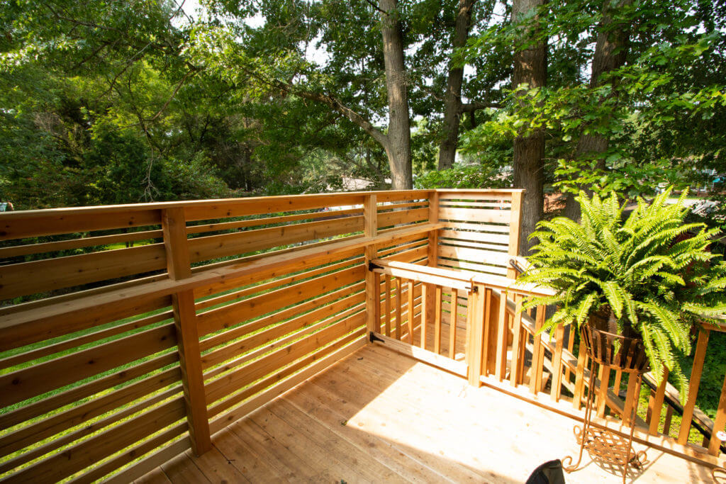 finished cedar deck corner with privacy railing by Odd Fellows Contracting in Haslett MI