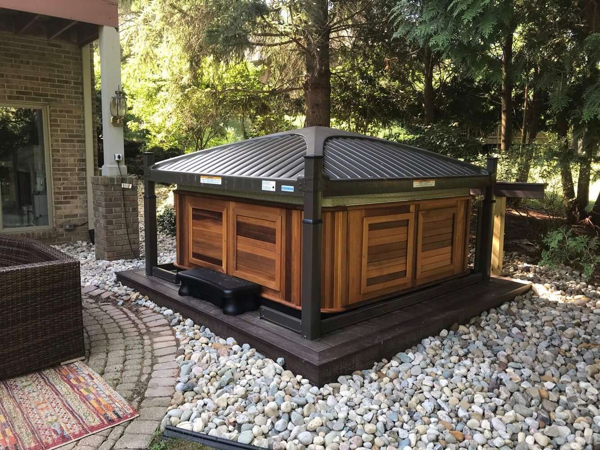 Backyard spa deck platform with stone landscaping in Okemos MI