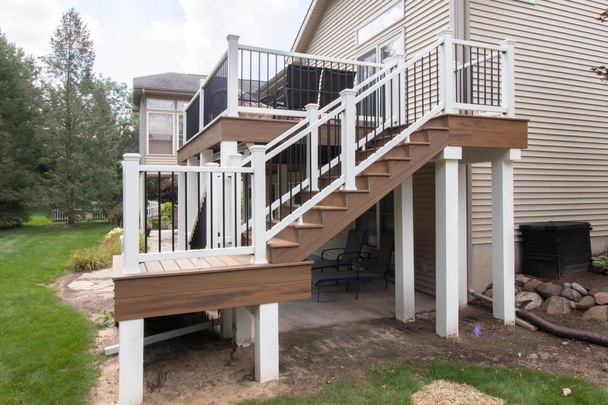 composite deck stairs and railing system installed during deck remodel by Odd Fellows Contracting in Williamston, MI