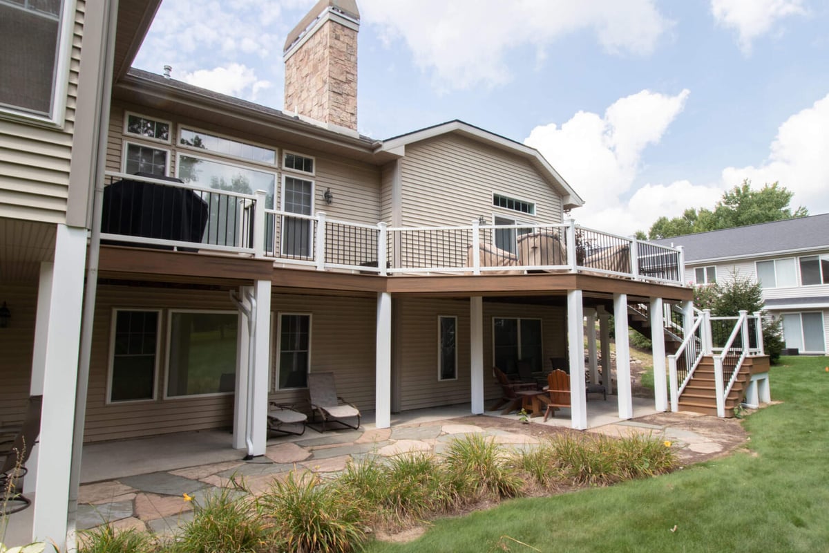 elevated backyard deck remodel with composite decking and modern railing by Odd Fellows Contracting in Williamston, MI