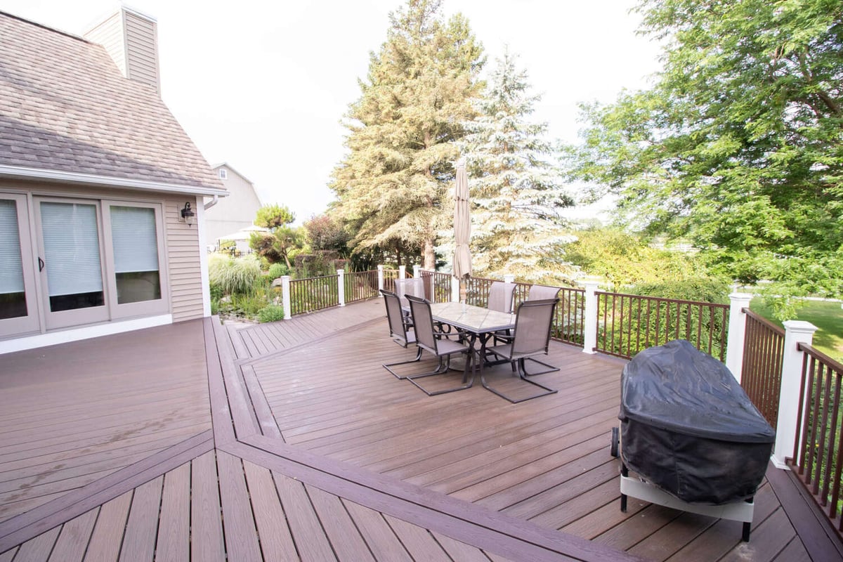 custom deck by Odd Fellows Contracting in Williamston MI with modern railing and wood-look boards