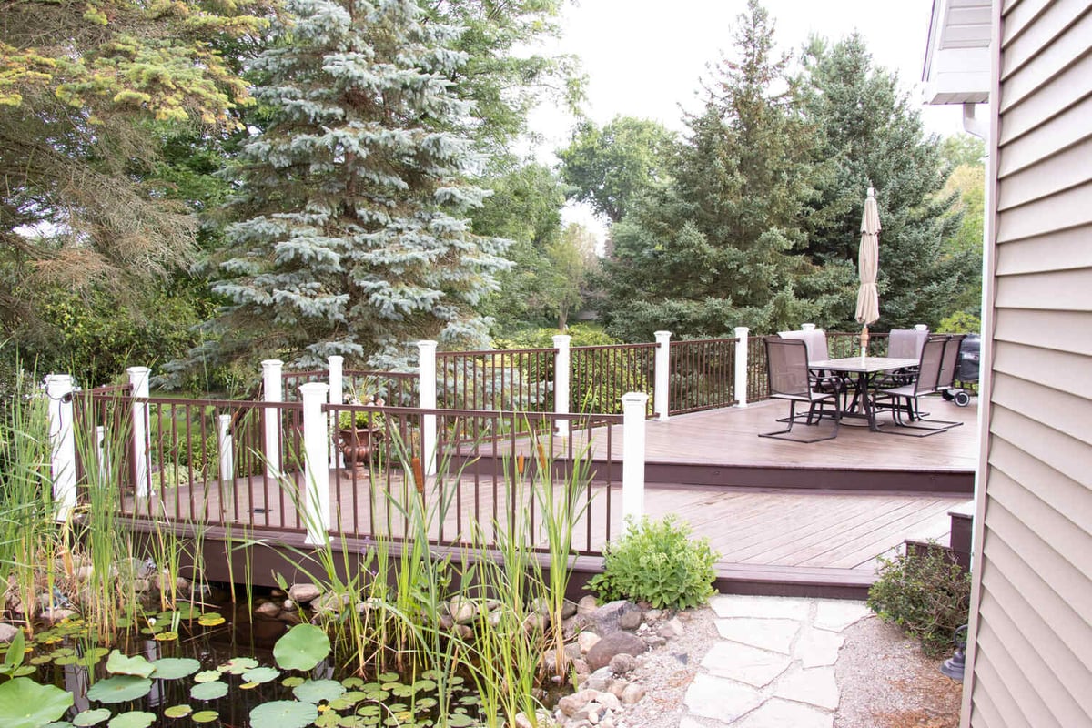 deck and outdoor living space by Odd Fellows Contracting in Williamston MI with multi-level decking and pond view