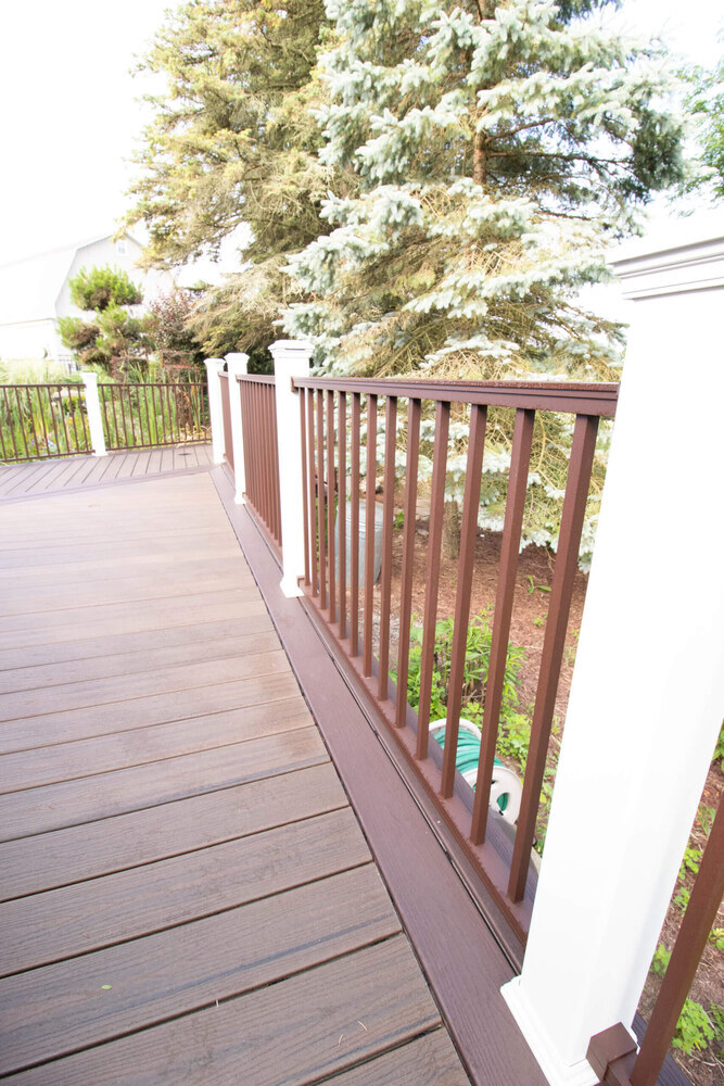 deck railing and walkway by Odd Fellows Contracting in Williamston MI with composite decking and posts