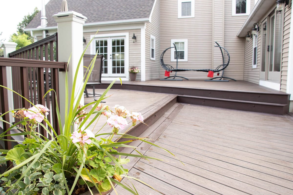 multi-level deck by Odd Fellows Contracting in Williamston MI with built-in steps and seating area