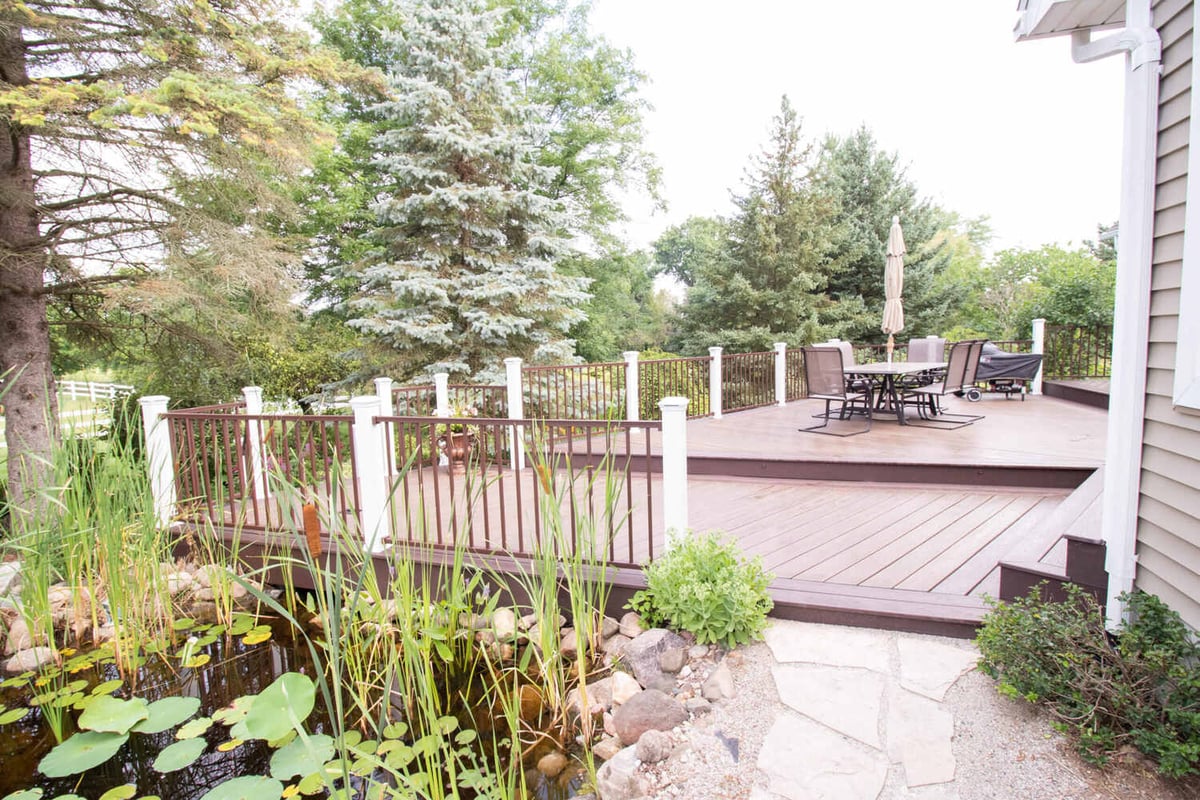 multi-level deck by Odd Fellows Contracting in Williamston MI with spacious seating and grill area