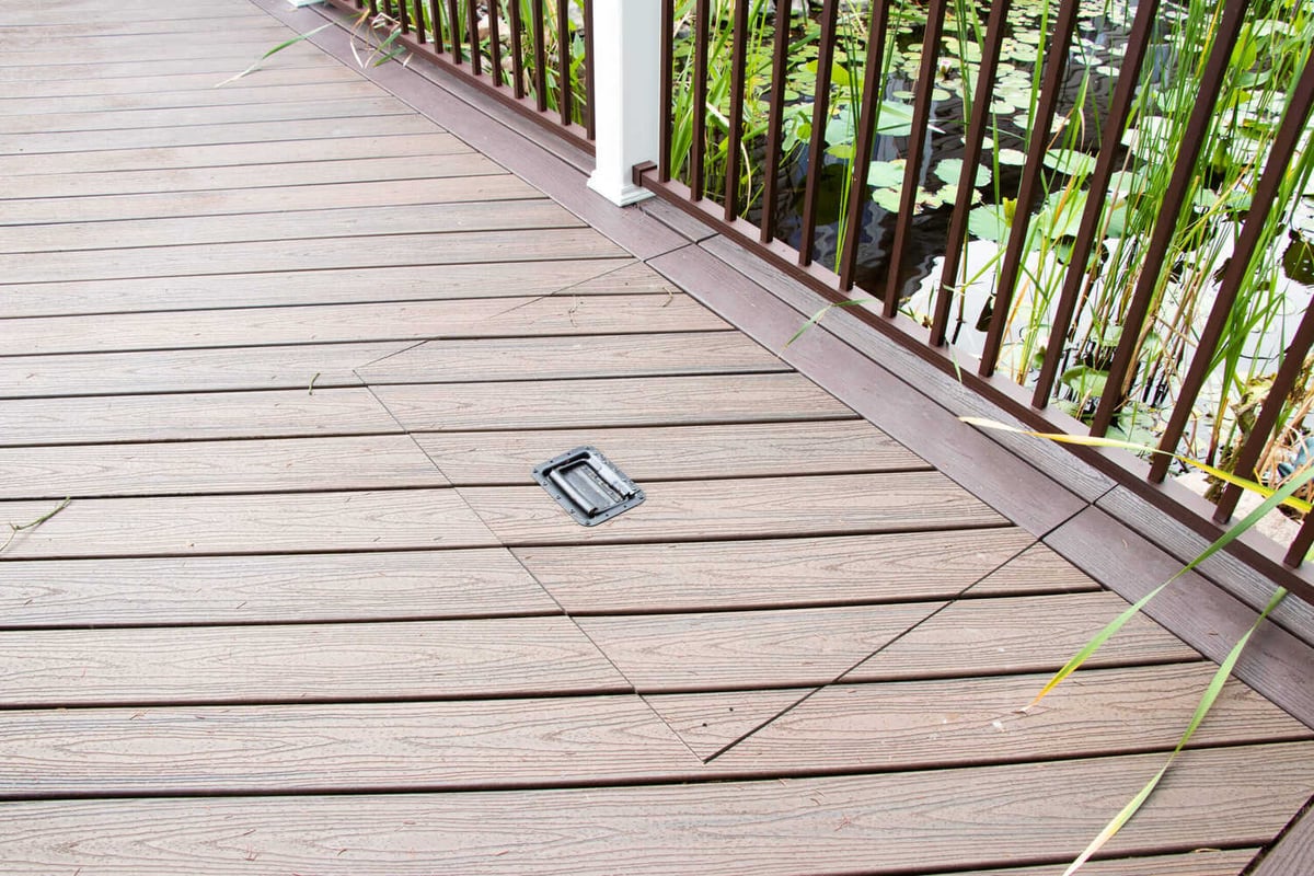outdoor deck boards by Odd Fellows Contracting in Williamston MI featuring integrated access panel