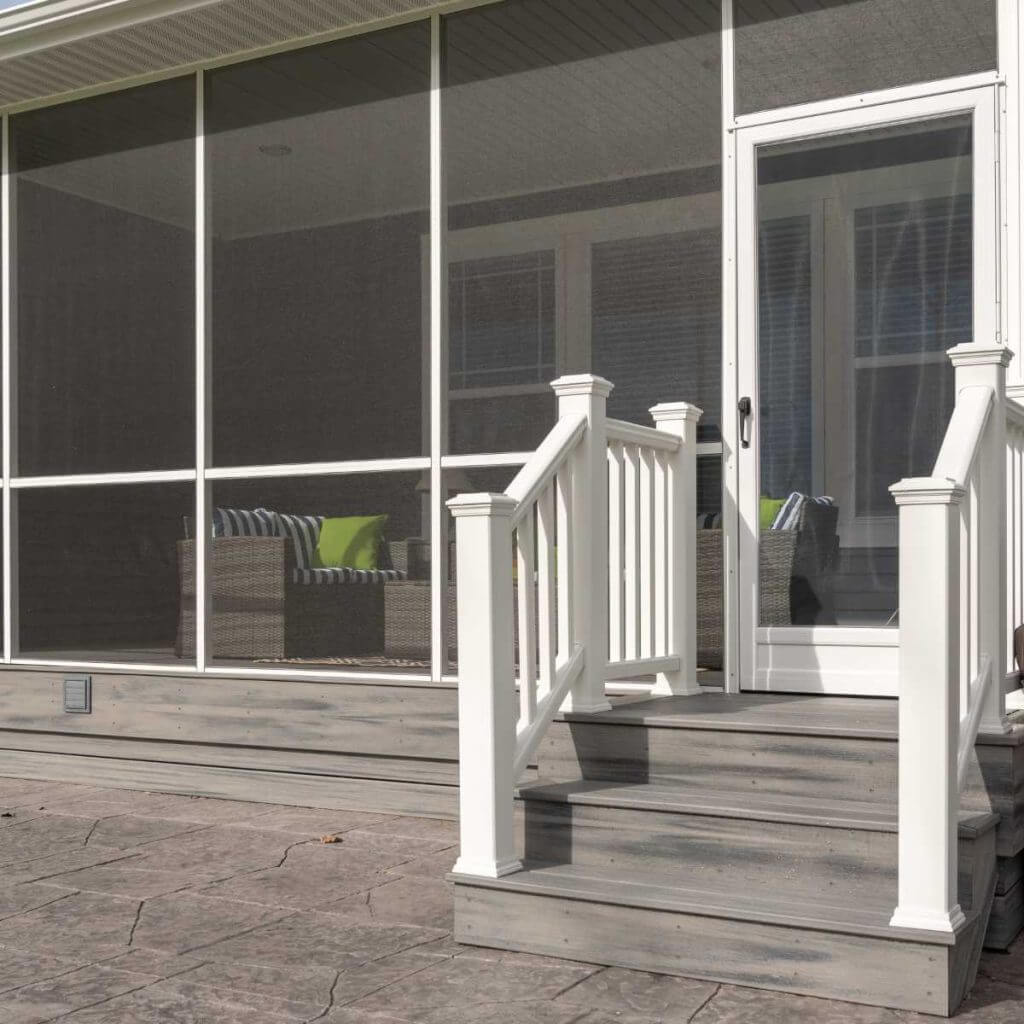 close up of deck stairs and railing leading to screened porch by Odd Fellows Contracting in Okemos MI
