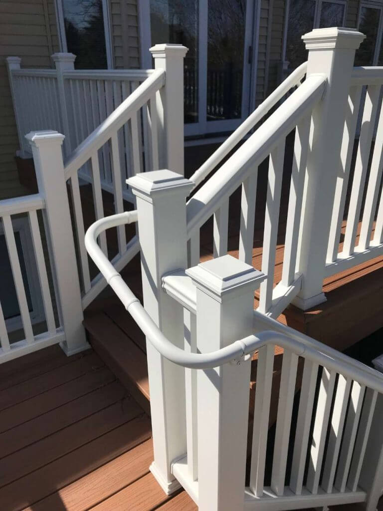 deck staircase renovation with white railing by Odd Fellows Contracting in Holt Michigan