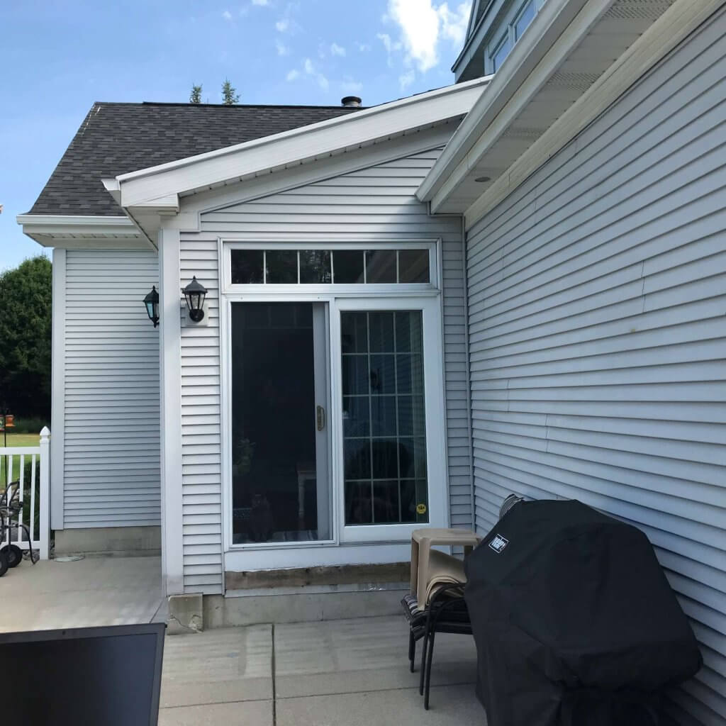 Backyard patio entrance before deck renovation by Odd Fellows Contracting in Williamston Michigan