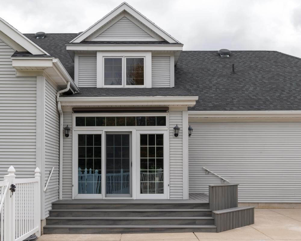 Custom outdoor living space with composite deck and sliding patio doors in Williamston MI