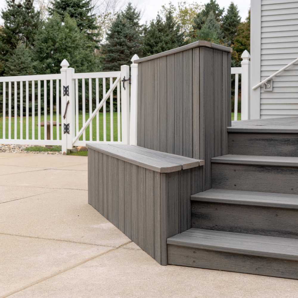 Low angle view of composite deck steps connecting patio and backyard in Williamston Michigan