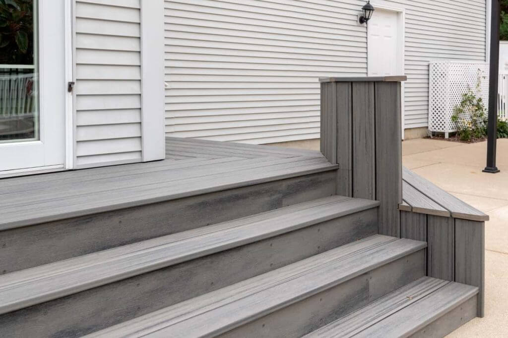 Outdoor living space renovation with deck platform and stairs by Odd Fellows Contracting in Williamston MI