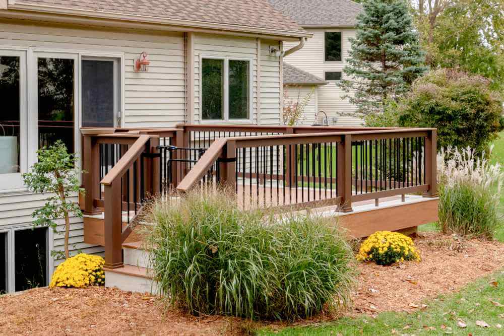 Composite backyard deck with black railing installed by Odd Fellows Contracting in Lansing Michigan