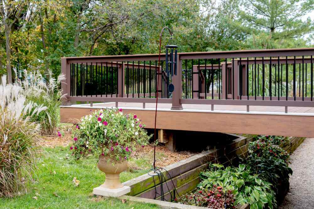 Composite deck with safety gate and railing built by Odd Fellows Contracting in Lansing MI
