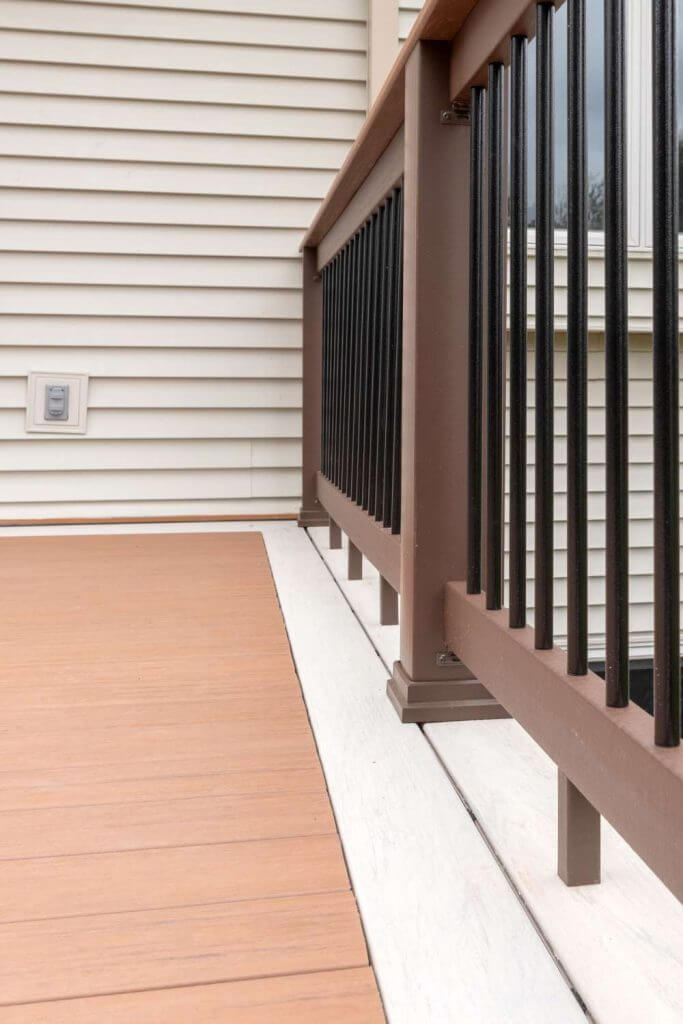 Custom composite deck railing and stair design built by Odd Fellows Contracting in Lansing Michigan