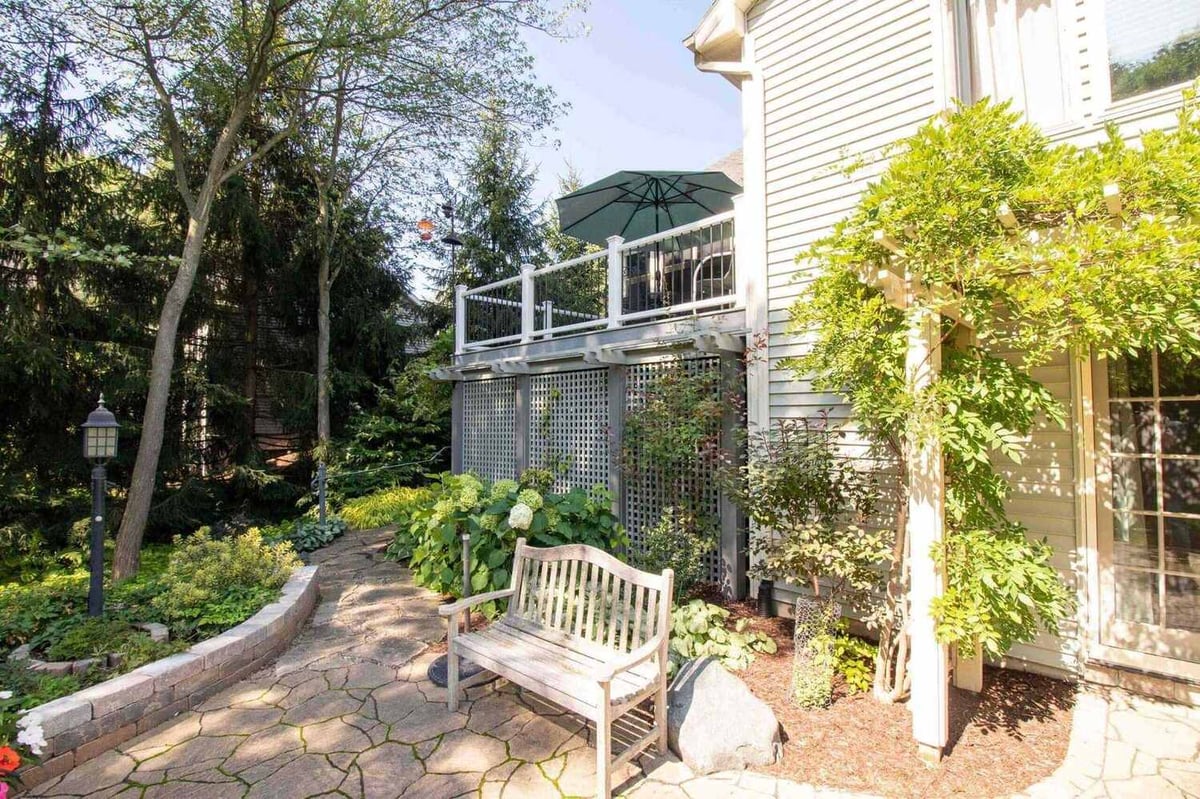 deck remodel with elevated composite deck and landscaped stone pathway by Odd Fellows Contracting in Williamston MI