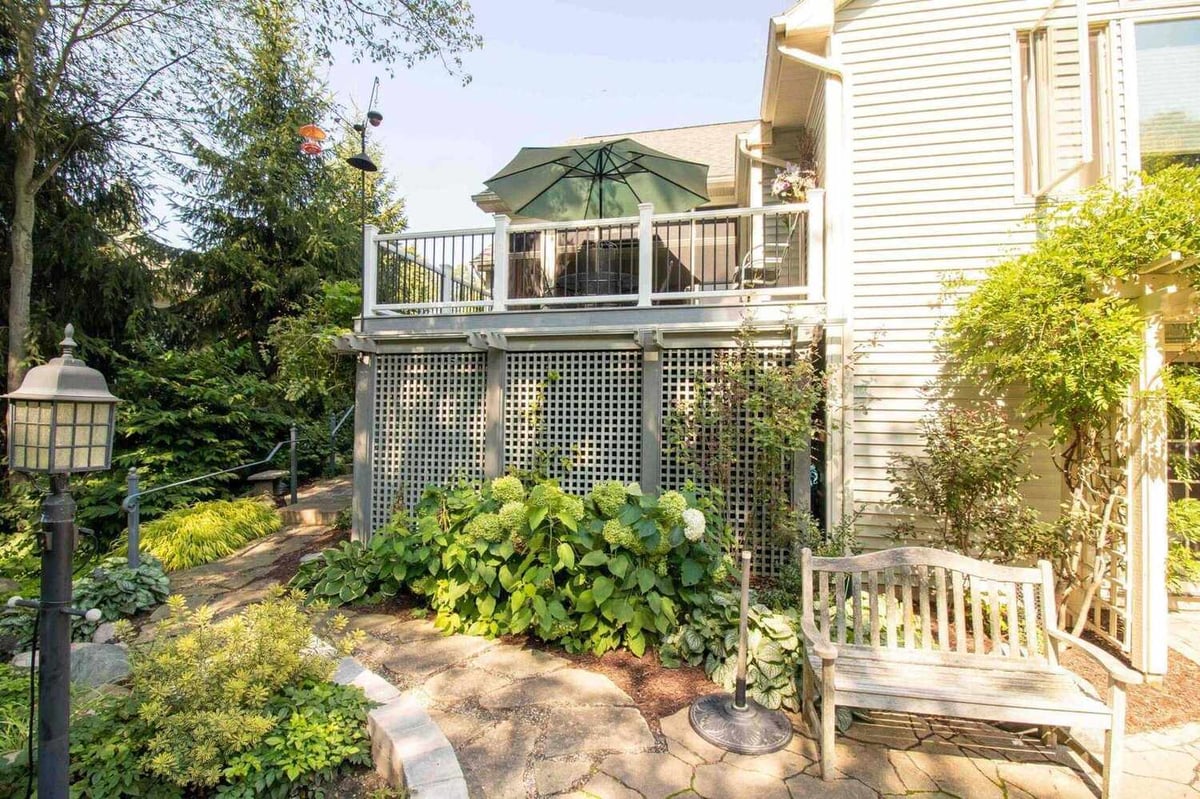 elevated composite deck renovation with black metal balusters by Odd Fellows Contracting in Williamston MI
