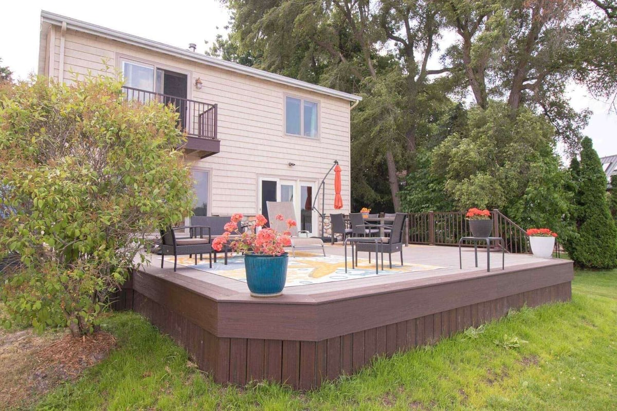 finished deck renovation with composite boards and outdoor lounge area by Odd Fellows Contracting in Haslett Lake MI