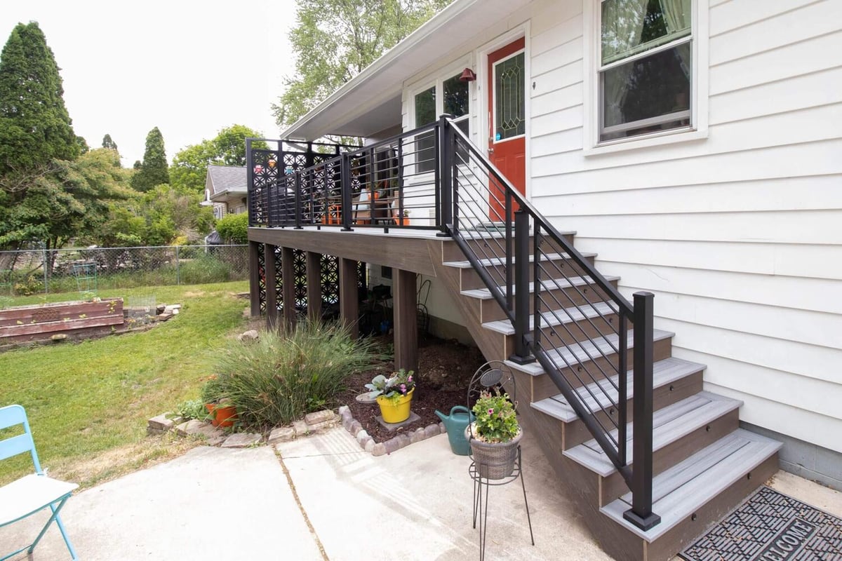 backyard deck renovation featuring composite steps and railing system by Odd Fellows Contracting in Lansing MI