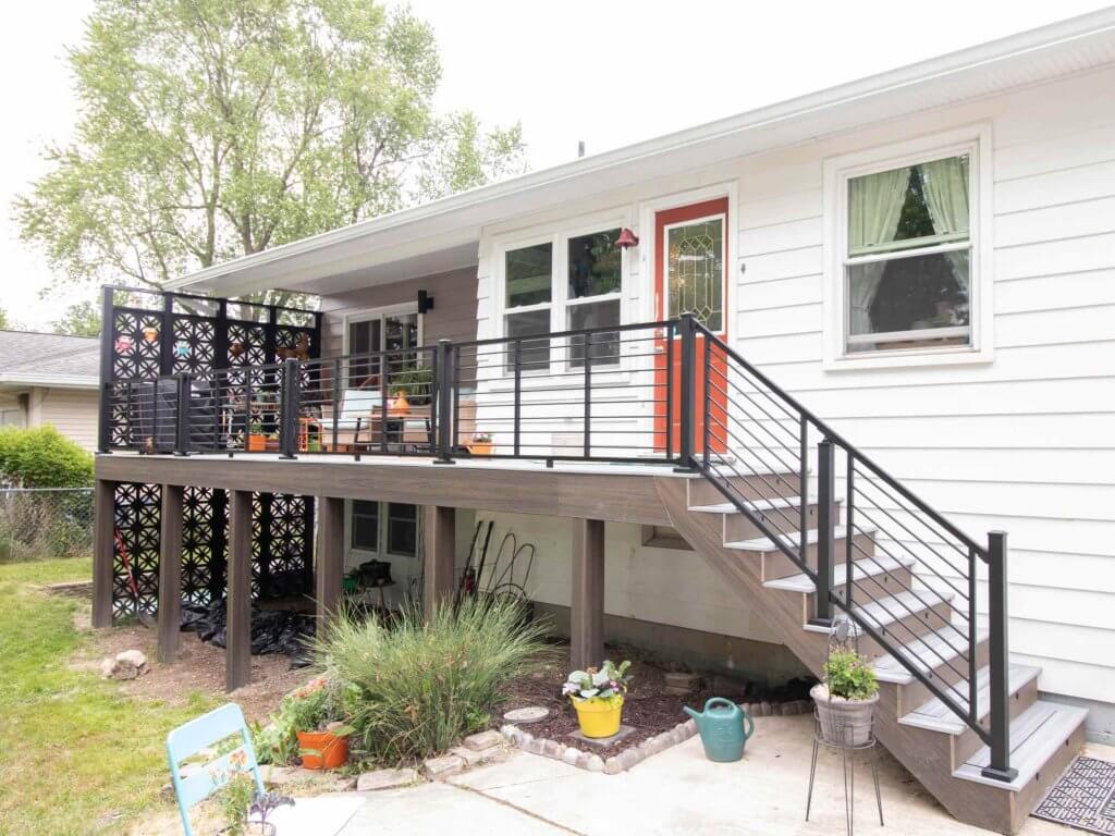 completed deck remodel with modern railing and composite decking by Odd Fellows Contracting in Lansing MI