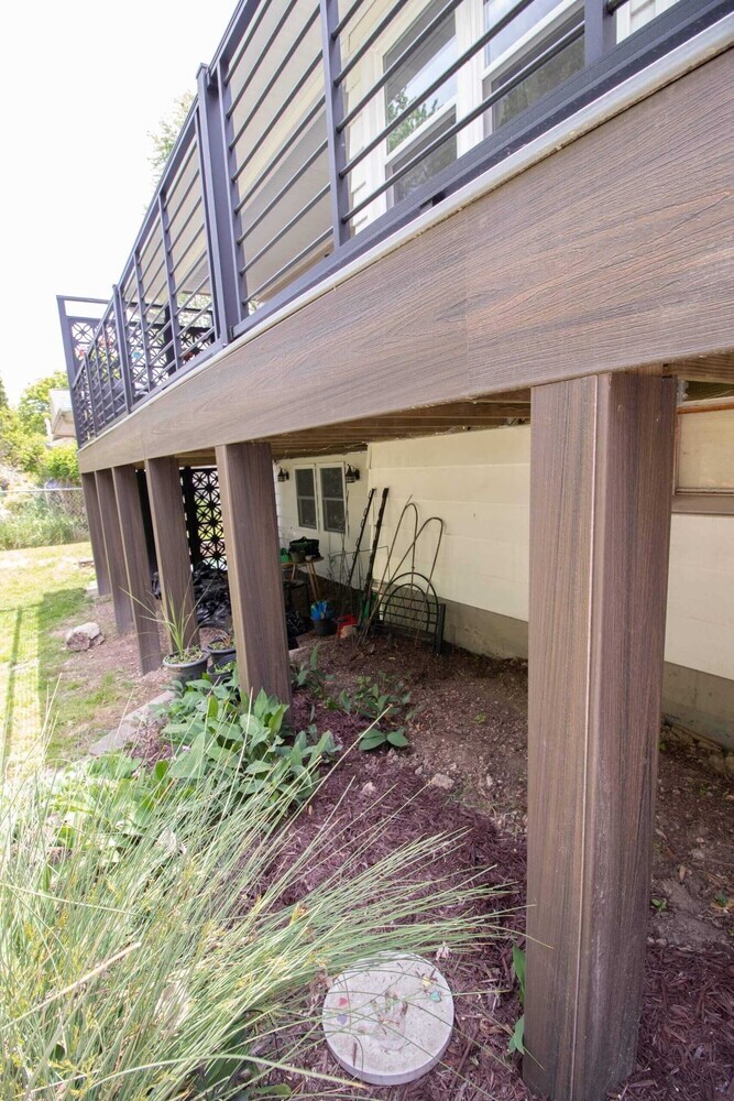 elevated composite deck remodel with modern railing and outdoor seating by Odd Fellows Contracting in Lansing MI