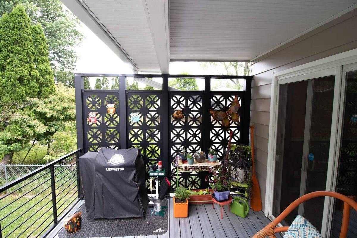 finished deck remodel with privacy panels and composite decking by Odd Fellows Contracting in Lansing MI