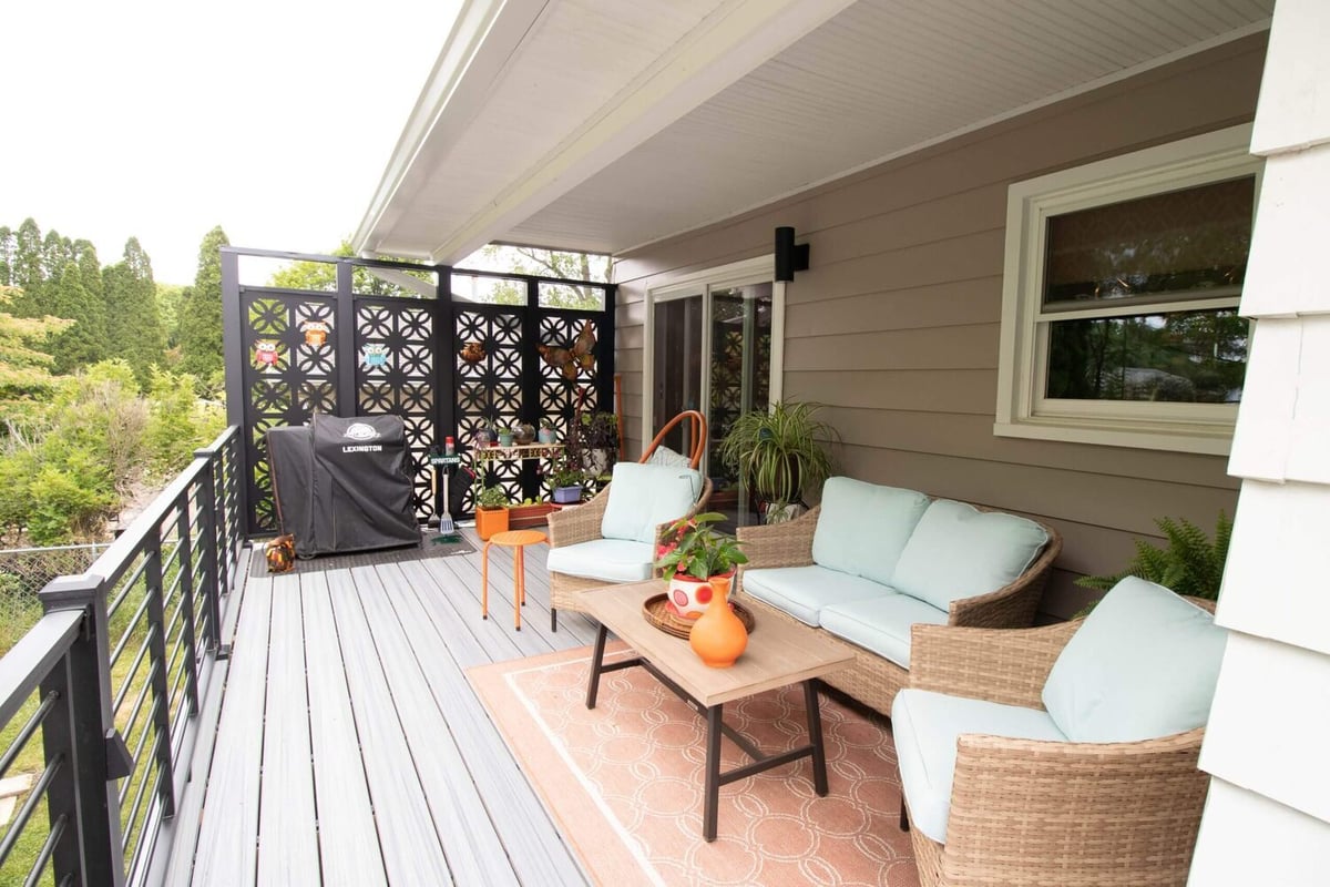 remodeled composite deck with outdoor seating area and privacy screen by Odd Fellows Contracting in Lansing MI