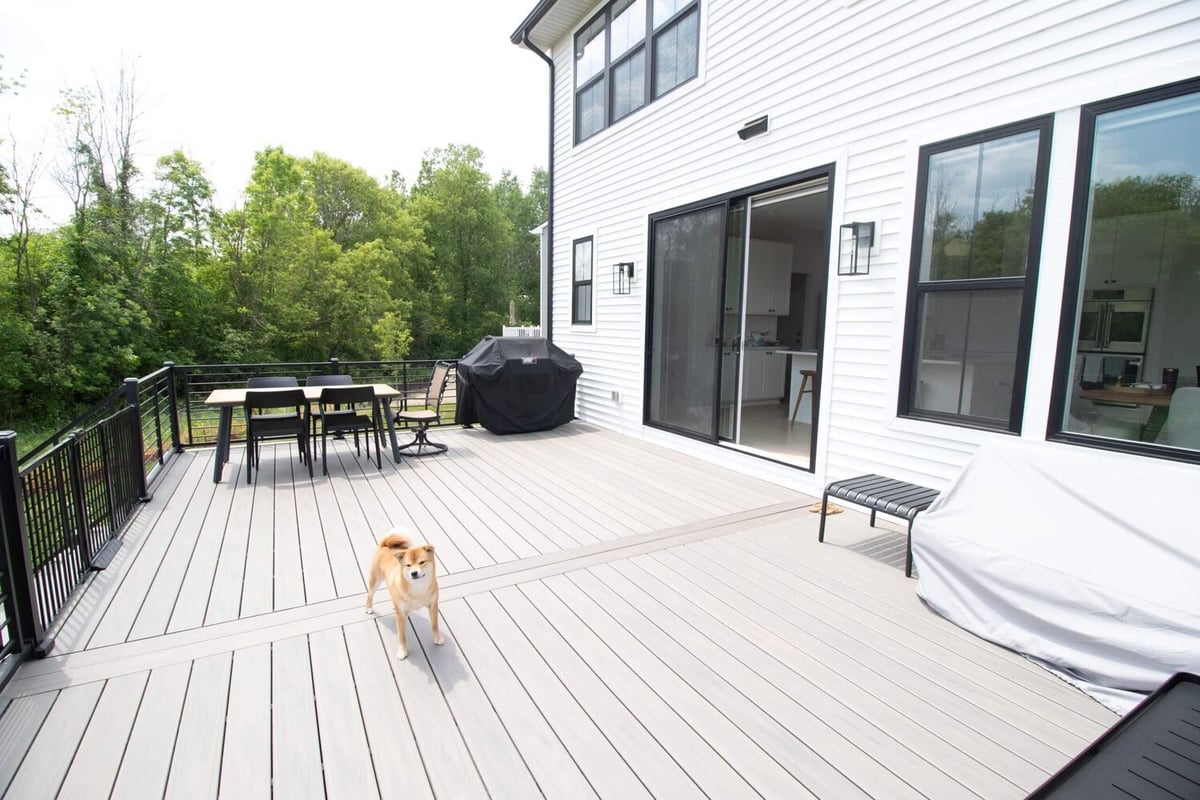 completed deck remodel with composite boards and railing system by Odd Fellows Contracting in Haslett MI
